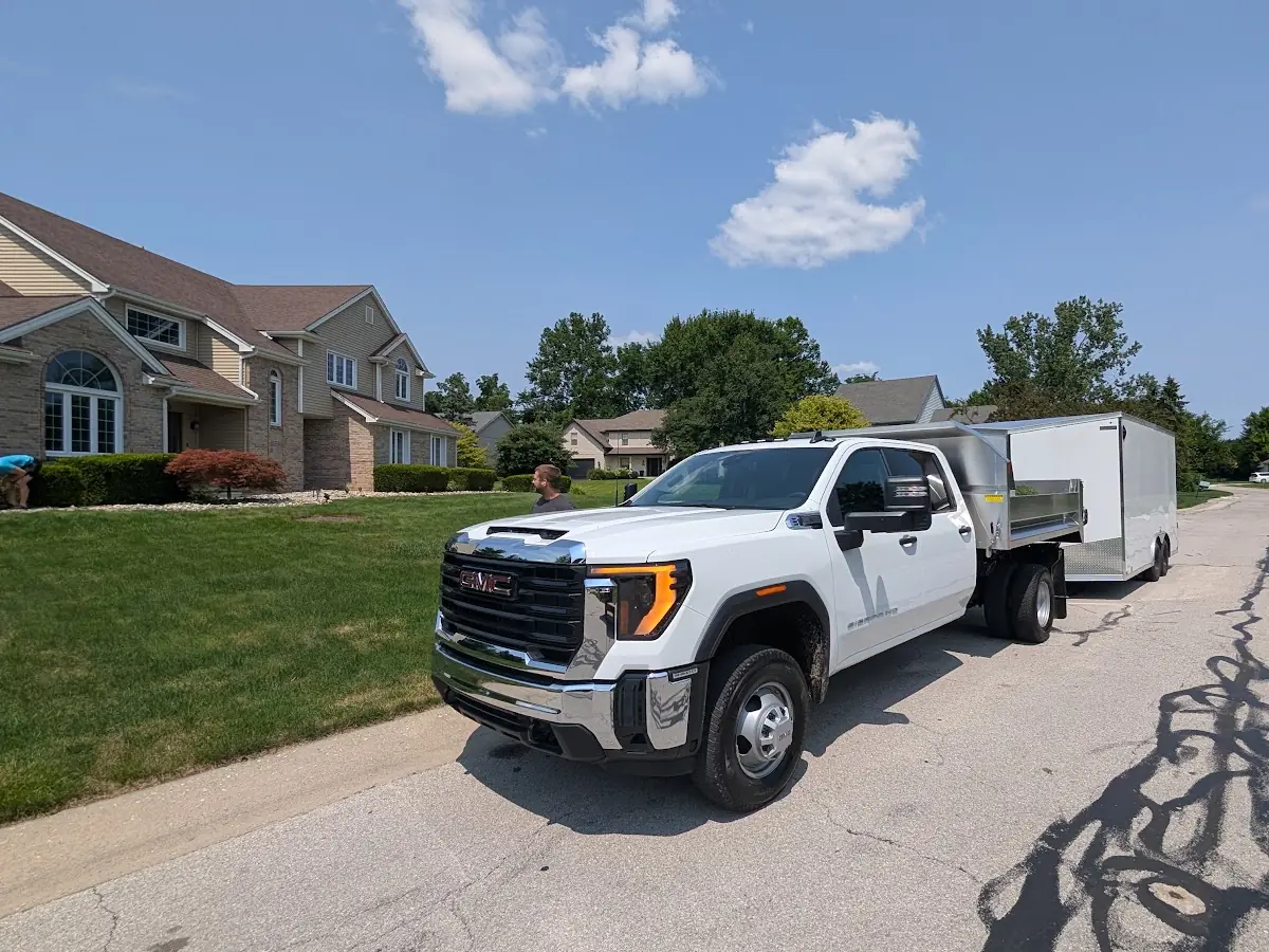 White pickup truck with a trailer parked on a residential street
